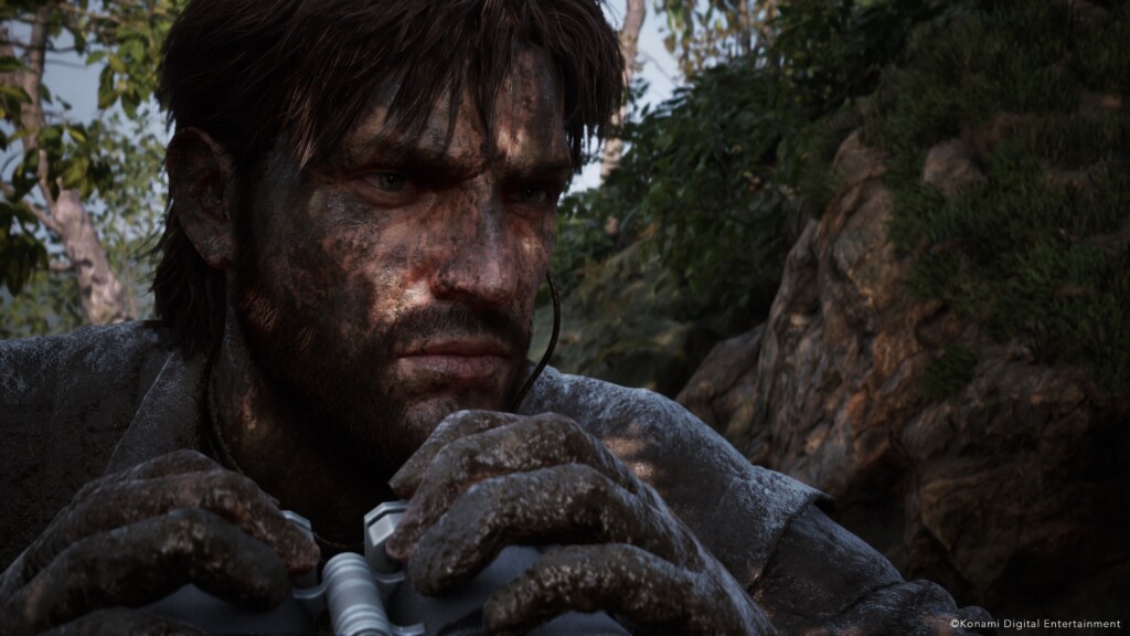 Naked Snake crouches with binoculars in a lush jungle environment in Metal Gear Solid Delta: Snake Eater.